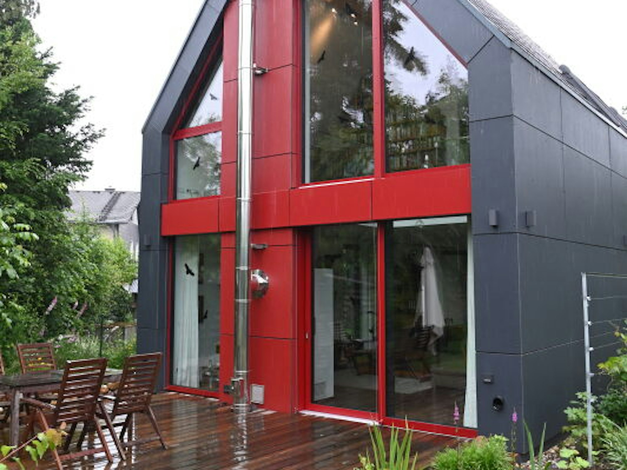 Dachform und graue Außenflächen knüpfen an bergische Architektur an, zugleich wirkt das Haus modern.