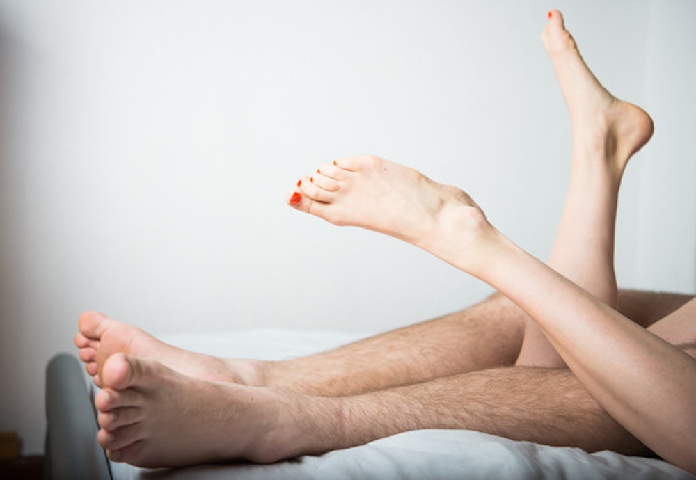 Das undatierte Symbolfoto zeigt ein Bett, auf dem eine Frau und ein Mann liegen. Beide sind nackt, man sieht nur die Beine.