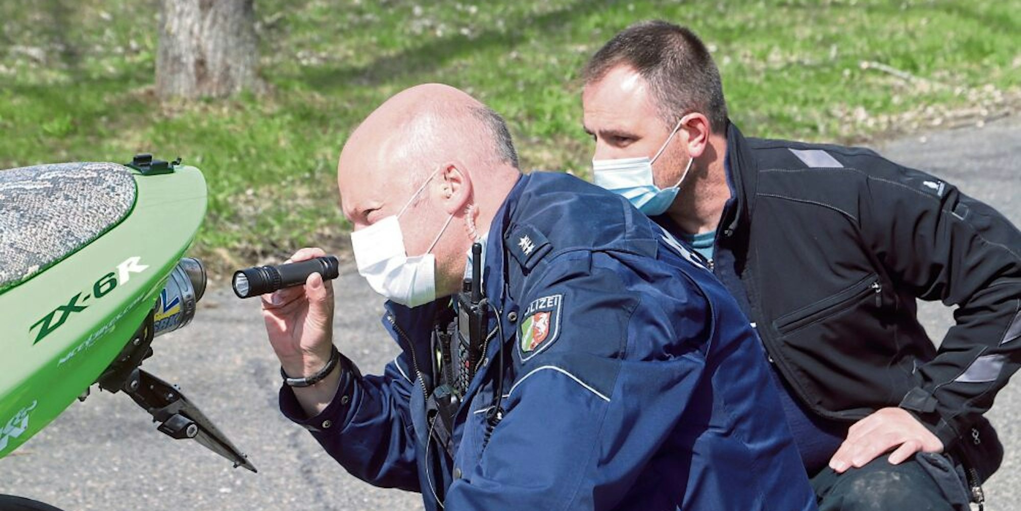 Den Auspuff eines Motorrads inspizierten Polizist Robert Schmitz (l.) und KfZ-Meister Christoph Weber.