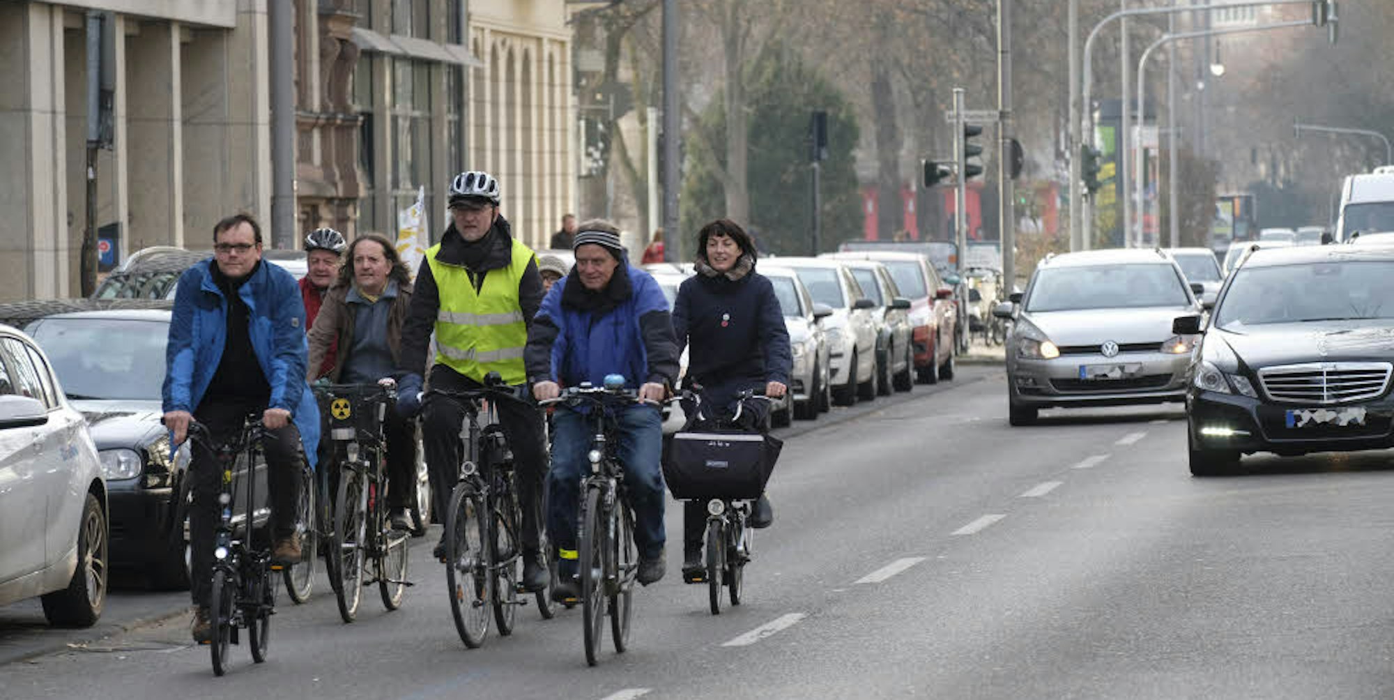 Einen ersten Versuch unternehmen Bezirksbürgermeister Andreas Hupke (gelbe Weste), Politiker und Vertreter der Fahrradverbände. Sie fahren mit ihren Rädern auf dem Hansaring. Die Autos müssen Rücksicht nehmen und dürfen nicht schneller als 30 fahren.