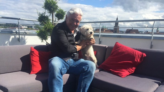 Uwe Rapolder auf seiner Dachterrasse in Heilbronn mit Hund Jimmy.