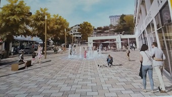 Die Visualisierung zeigt die Schloßstraße nach Abschluss der Bauarbeiten. Menschen flanieren über das Pflaster, ein Brunnen sprudelt