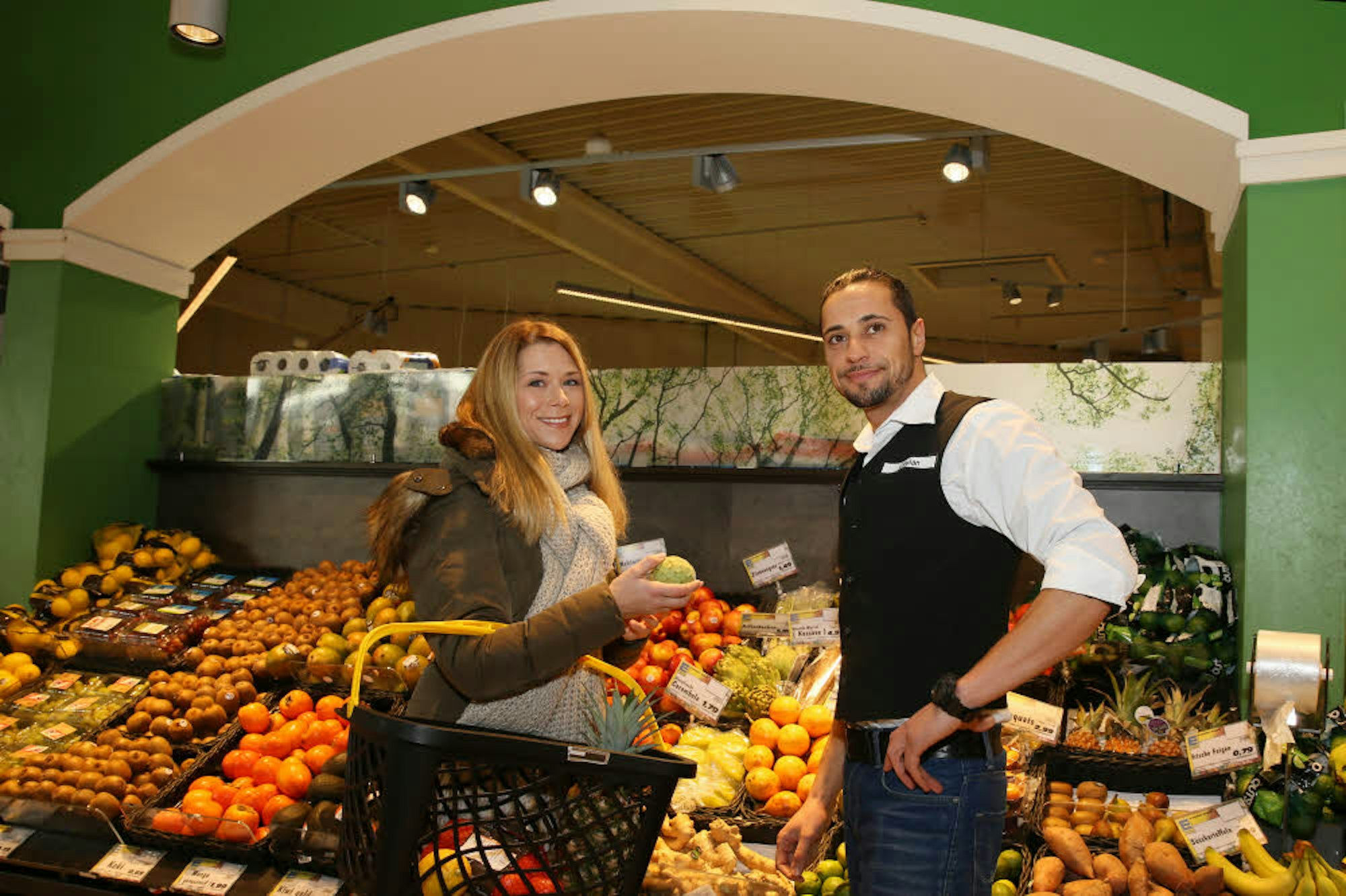 Ferdi Ceylan berät Tanja Szewczenko an der Obst-Theke im Edeka-Markt.