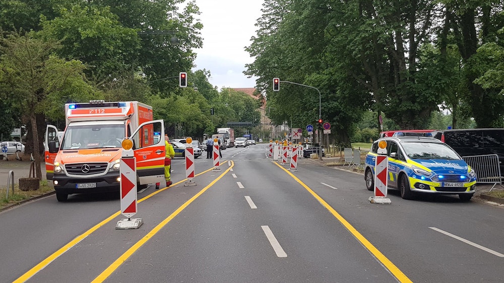 Ein Rettungswagen und ein Streifenwagen stehen auf einer Straße. In Köln-Zollstock soll eine Radfahrerin am Mittwoch ein Kind auf einem Fahrradweg angefahren und anschließend Unfallflucht begangen haben.