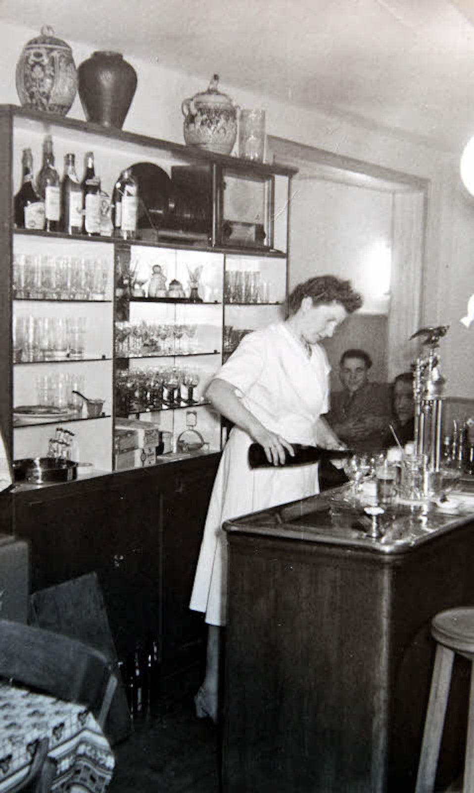Lotte Haas, die Mutter von Klaus Haas, steht auf dem linken Bild am Tresen. Rechts ist eine Biergarten-Szene aus dem Jahr 1915 zu sehen.
