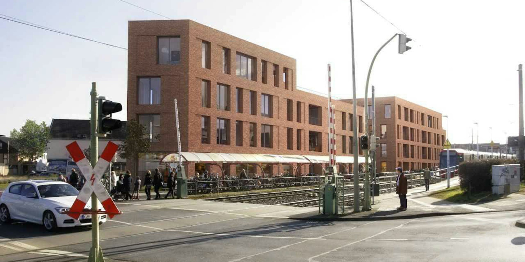 Noch wird wild geparkt am Sürther Bahnhof, doch damit ist bald Schluss. Das neue Bahnhofsgebäude (Bild rechts) soll so aussehen.