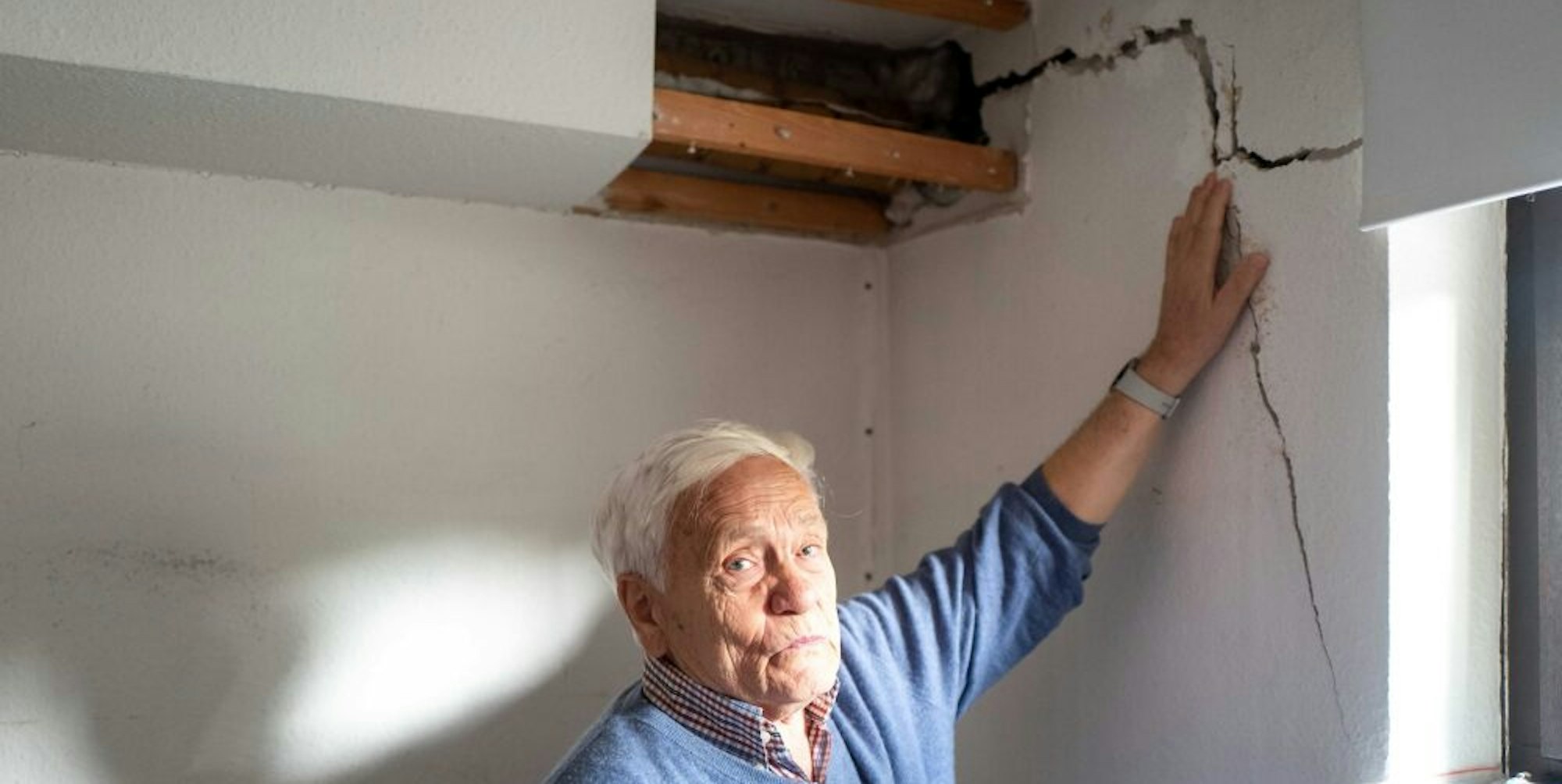 Der Zülpicher Rolf Meuser deutet auf einen verhältnismäßig kleinen Riss in seinem Keller. Eine Haushälfte ist um etwa zehn Zentimeter abgesackt.